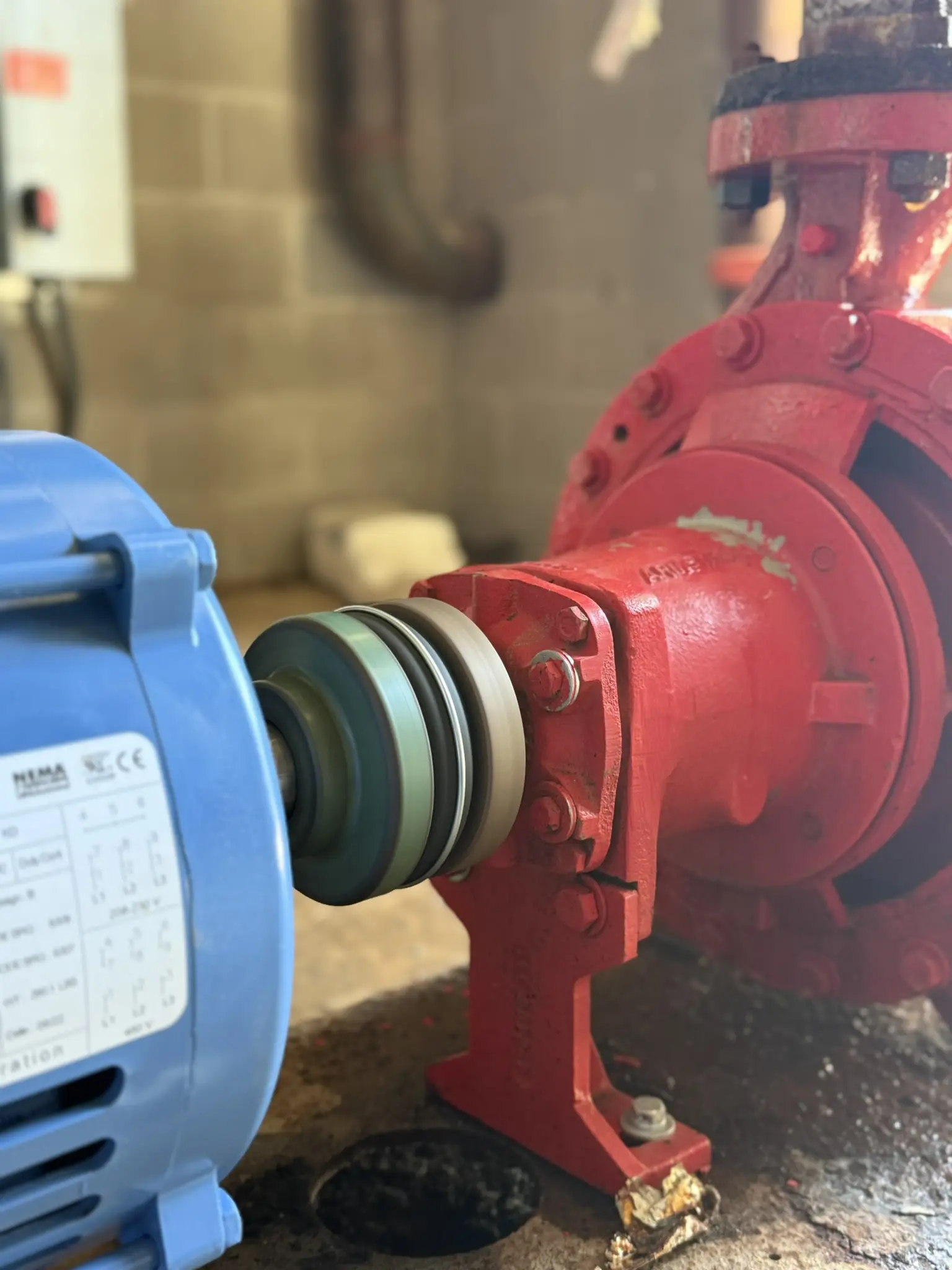 Blue motor connected to red industrial pump.