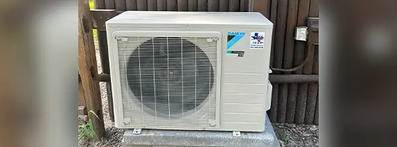 Outdoor air conditioning unit on concrete slab.