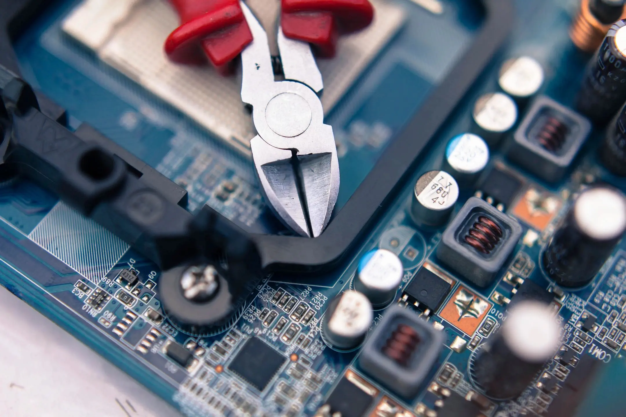 Pliers on electronic circuit board.