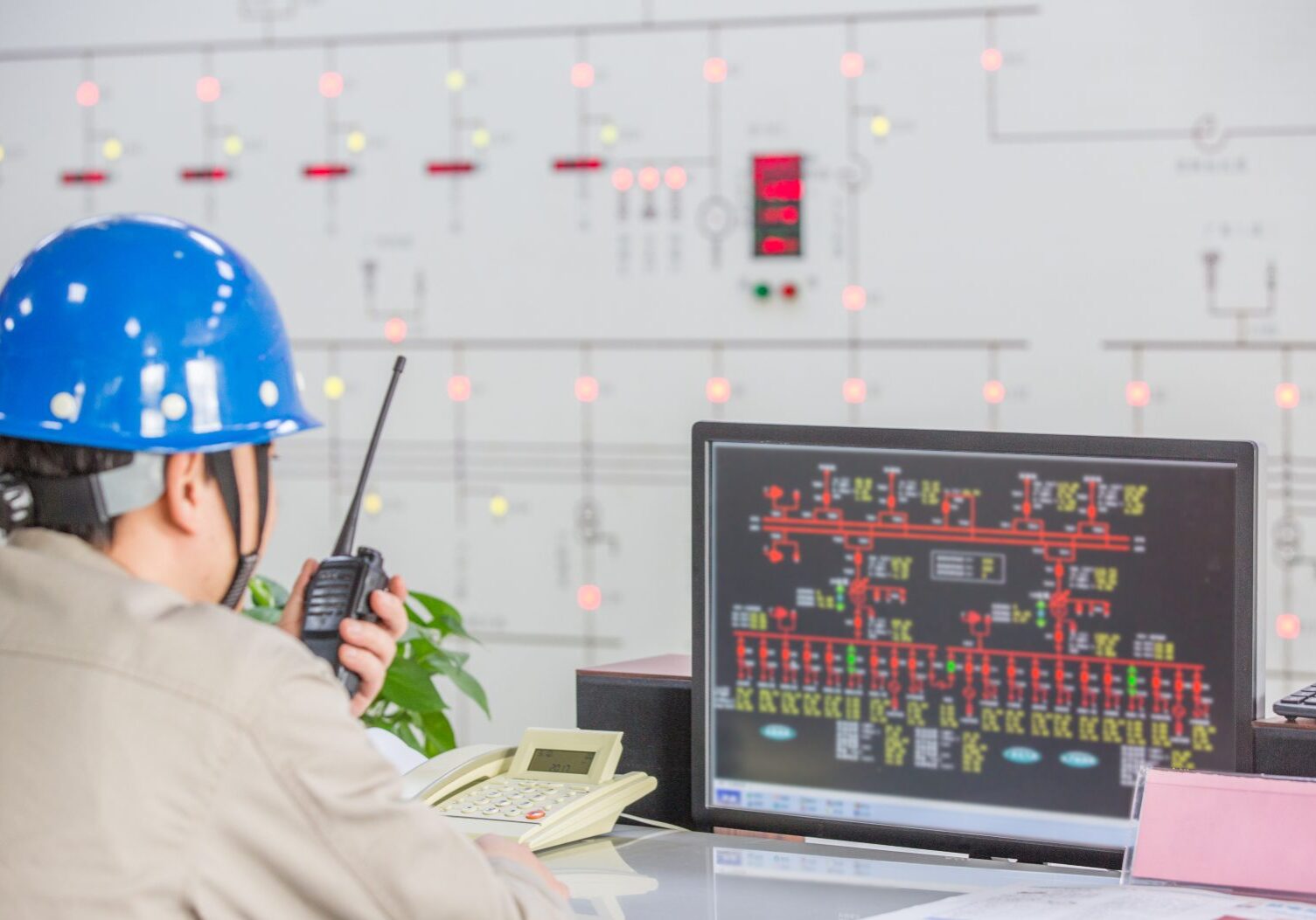 Engineer monitoring control panel with radio.